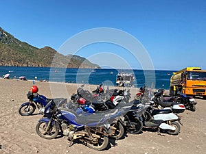 Motorcycles parked in a beach near the sea