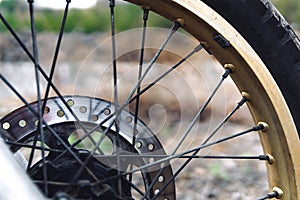 Motorcycles wheels rubber. spoked wheel, used brake disc, brake caliper and pads. Weight balancing wheel