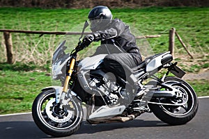 Motorcyclist biker on road photo