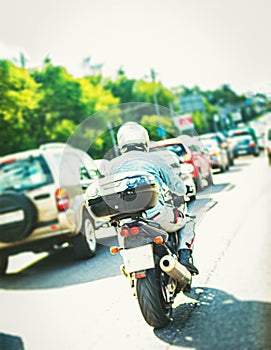 motorcyclist in city highway at rush hour