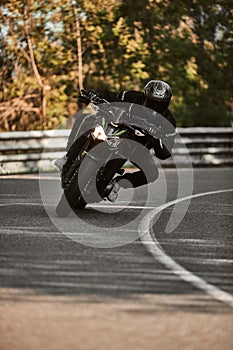 Motorcyclist in full gear cornering on road