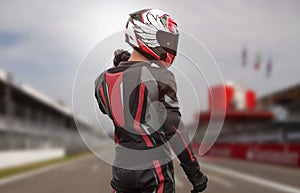 Motorcyclist in full gear and helmet on the race track