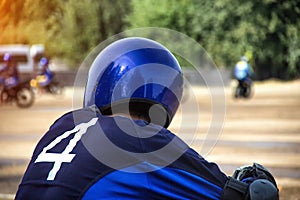 Motorcyclist in a helmet on the background of motorcycle racing competitions, copy space