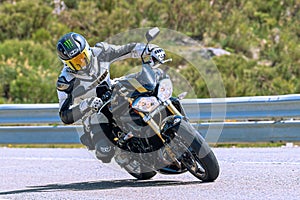 motorcyclist riding on his motorcycle on the road taking a sharp curve