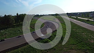 Motorcyclist ride on race track in countryside road. Drone view moto competition