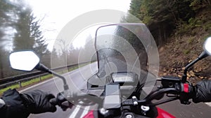 Motorcyclist Rides on a Mountain Road in Bad Weather, Storm, Rain and Fog. POV.