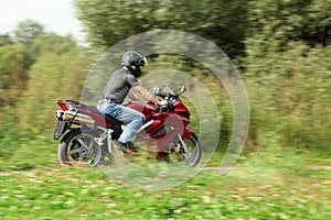 Motorcyclist riding on country road