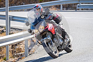 motorcyclist riding on his motorcycle on the road taking a sharp curve