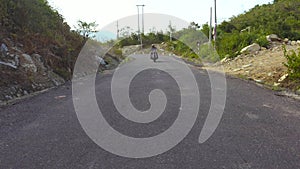 Motorcyclist riding on motorcycle on mountain road close up. Man motorcyclist driving on motorcycle at winding road in