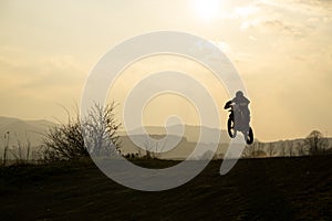 Motorcyclist riding off road during sunset. Slovakia