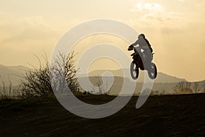 Motorcyclist riding off road during sunset. Slovakia