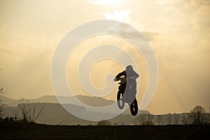 Motorcyclist riding off road during sunset. Slovakia