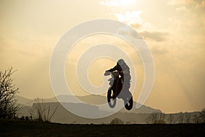 Motorcyclist riding off road during sunset. Slovakia