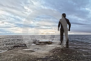 Motorcyclist on Rocky Shore