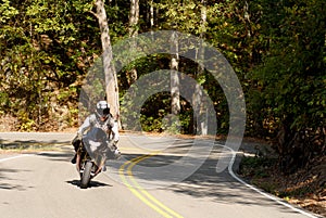 Motorcyclist on a winding road photo