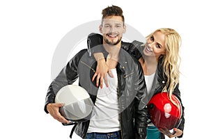 Motorcyclists couple with helmets in hand