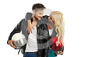 Motorcyclists couple with helmets in hand