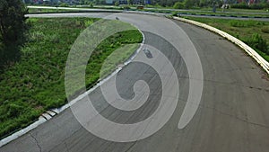 Motorcyclists ride on racing track. Aerial view moto race on racing track
