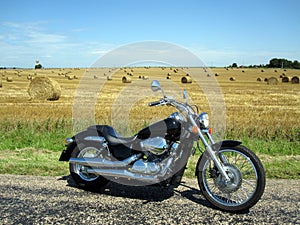 Motorcyle near hay field