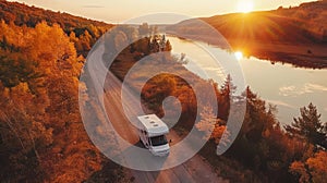 Motorhome driving through autumn forest at sunset, aerial view of scenic road trip adventure