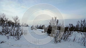 Motorhome at frozen lake Tornetrask in Abisko National Park in Sweden in winter