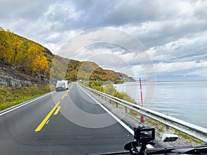 A motorhome parked by the road in the autumn landscape of the Lyngen Alps, Northern Norway, with mountains photo