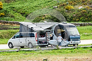 Motorhome RV and campervan are parked on a beach