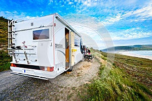 Motorhome RV and campervan are parked on a beach