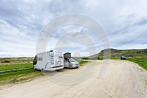 Motorhome RV and campervan are parked on a beach.