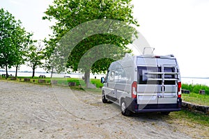 Motorhome RV campervan parked on a river side beach for night