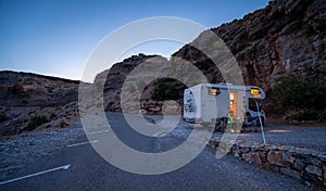 Motorhome RV parked on beach under a cliff, Crete, Greece