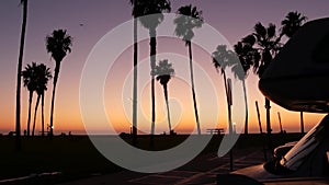 Motorhome trailer, caravan for road trip, palm trees, California beach at sunset