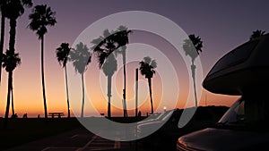 Motorhome trailer, caravan for road trip, palm trees, California beach at sunset