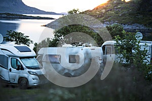 Motorhomes in sunset by the sea.