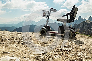 Motorised wheelchair for disposable people, Mobile electric buggies on the mountain, Dolomites, Italy.