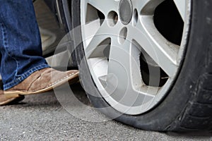 Motorist Kicking Flat Tyre On Car