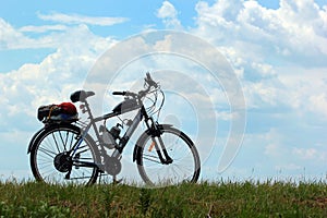 Motorized bicycle on green grass against blue sky