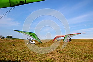 Motorized gliders stand on the ground against of a blue sky