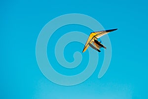 Motorized Hang Glider Flying On Blue Clear Sunny Sky Background