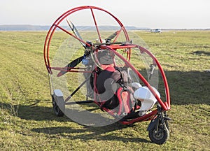 Motorized paraglider on airfield photo