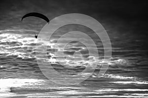 Motorized paraglider flying up high on the sky