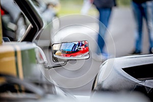 Motorsport car driver detail on rear view mirror