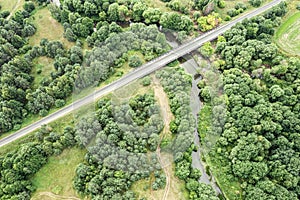 Motorway bridge over river in sunny summer day. countryside landscape. aerial top view