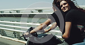 On the motorway portrait of a beautiful couple on the motorcycle have a ride , happy and smiling lady , beautiful sunny