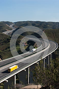 Motorway with yellow and white trucks