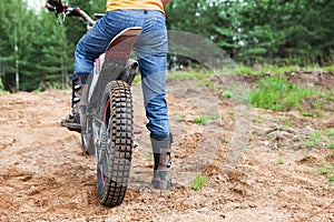 Mototrial rider standing on motorcycle in sand. Extreme sports on motorcross motorcycles. Copy space photo
