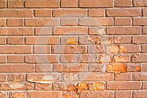 A mottled red brick wall