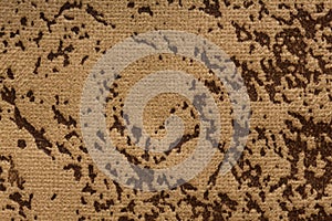 Mottled textile background in beige-brown hue.