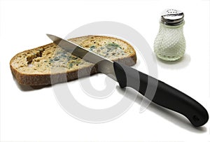Mouldy bread with knife