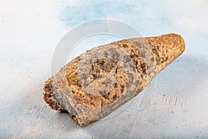 Mouldy moldy bread. Mould growing old bread on wooden table. Wastage of bread and stale bread